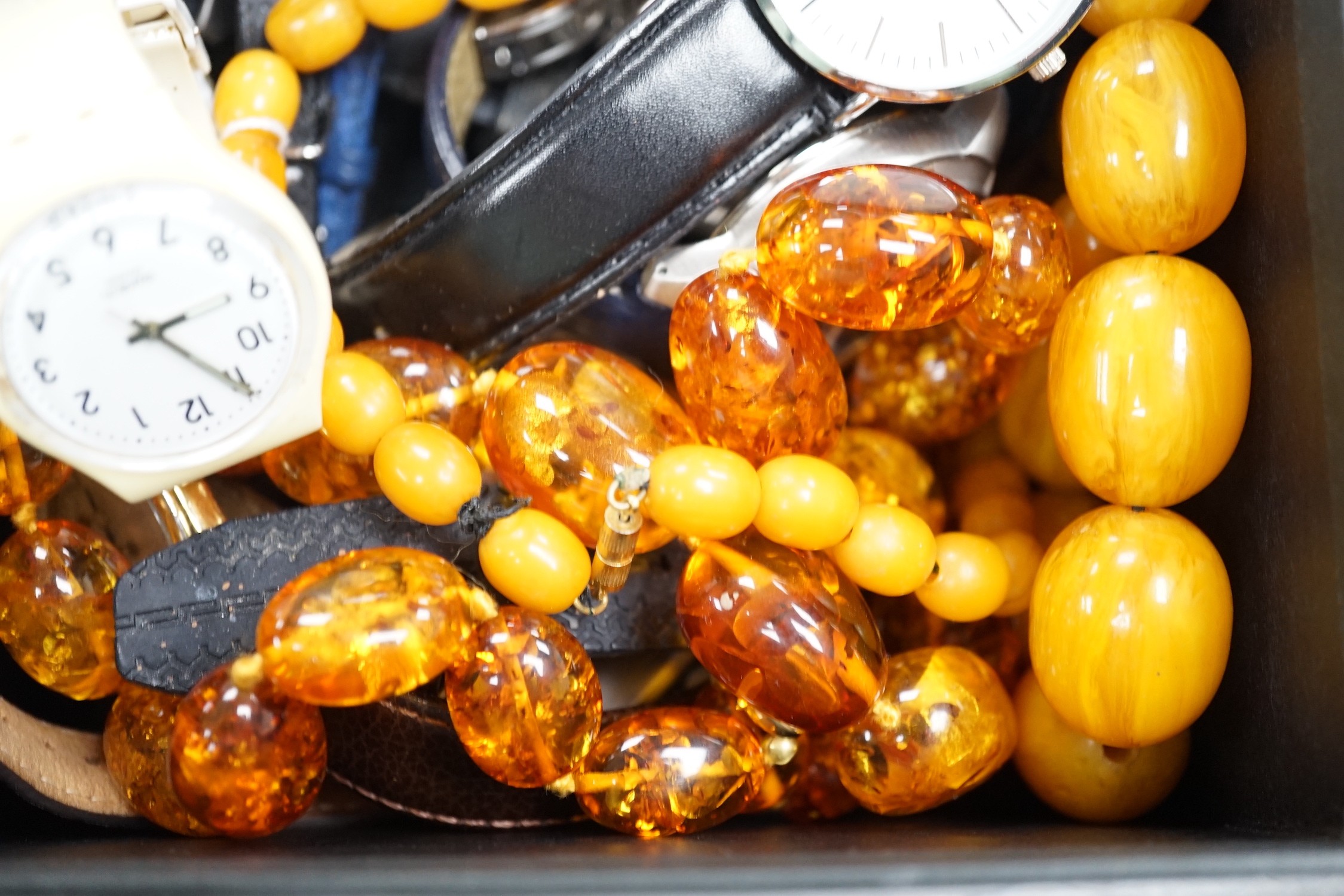 A quantity of assorted gentleman's modern wrist watches and two necklaces including amber style.